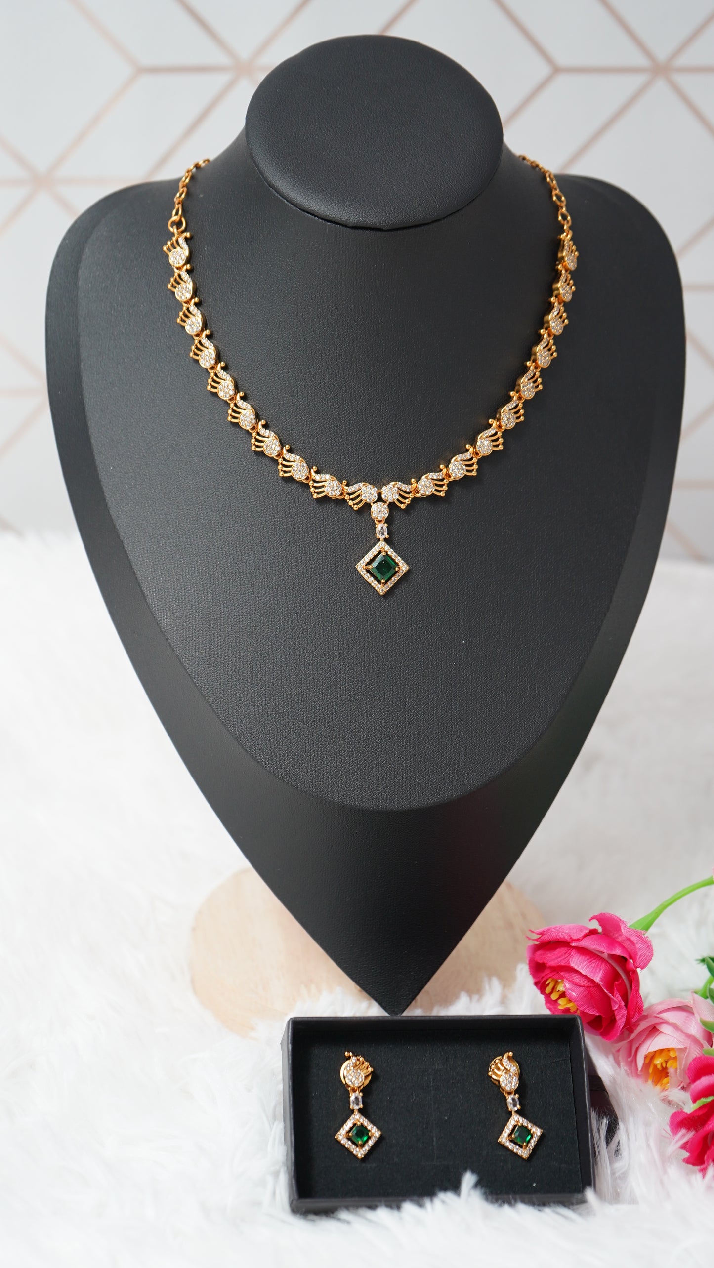 Intricate peacock detailing necklace designed with a gold finish and green designer stone