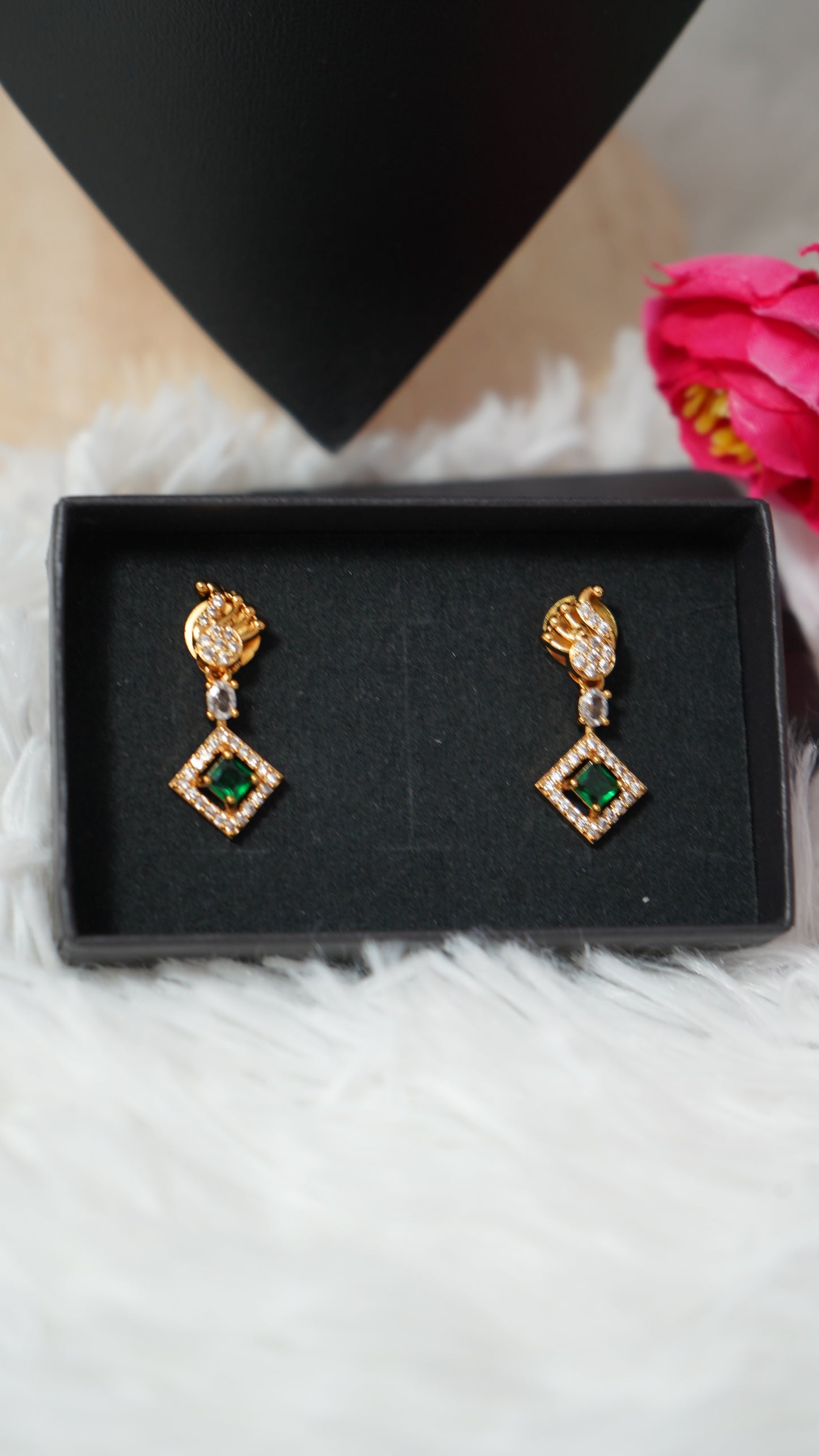 Intricate peacock detailing necklace designed with a gold finish and green designer stone
