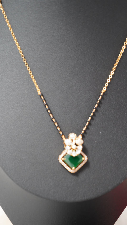 Beautiful short mangalsutra chain featuring black beads and green accents with Ear tops