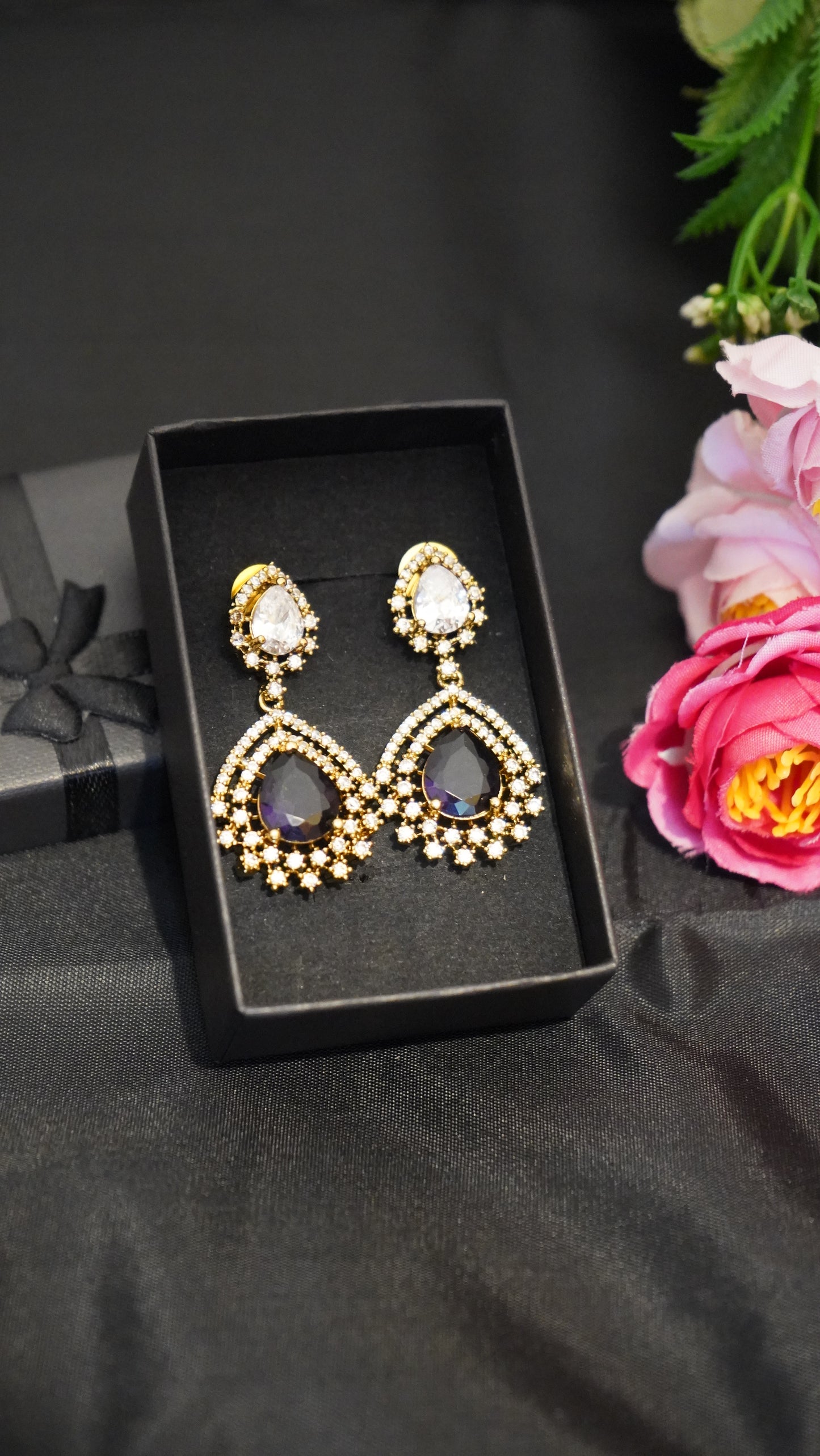 Diamond finish earrings with dark purple stone