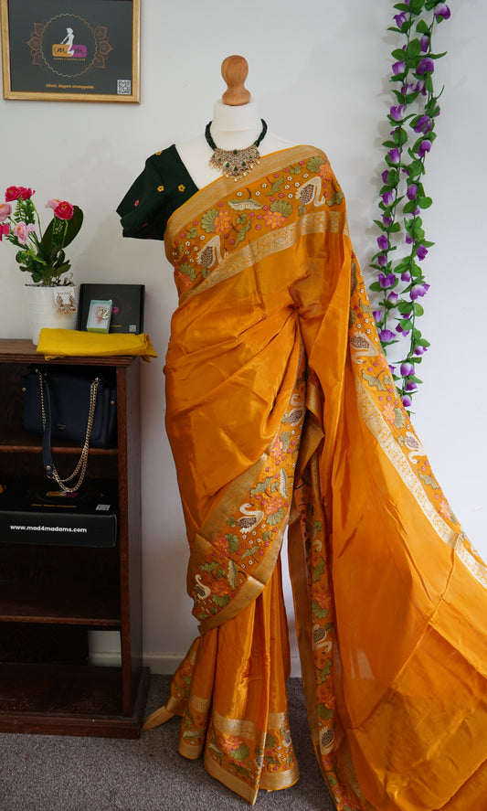 Mysore crepe silk saree with green stitched embroidered blouse - Orange, & floral zari motifs