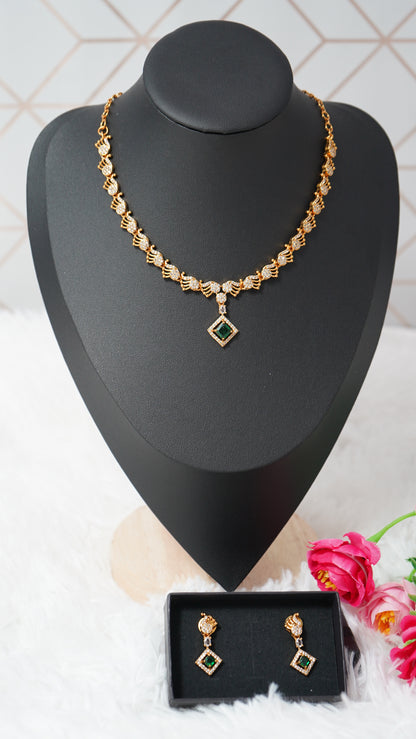 Intricate peacock detailing necklace designed with a gold finish and green designer stone