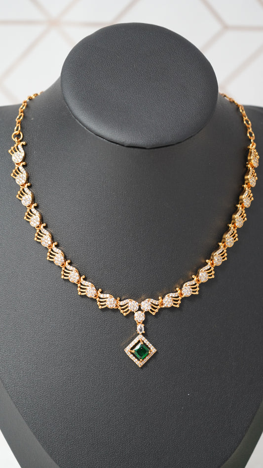 Intricate peacock detailing necklace designed with a gold finish and green designer stone