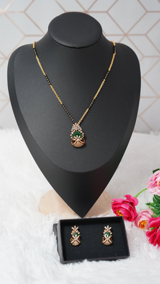 Modern short mangalsutra chain with earrings accented with green stone