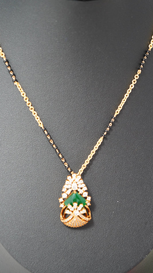 Modern short mangalsutra chain with earrings accented with green stone