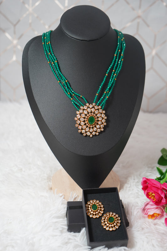 Necklace featuring green beads and studded Kundan work