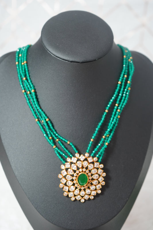 Necklace featuring green beads and studded Kundan work