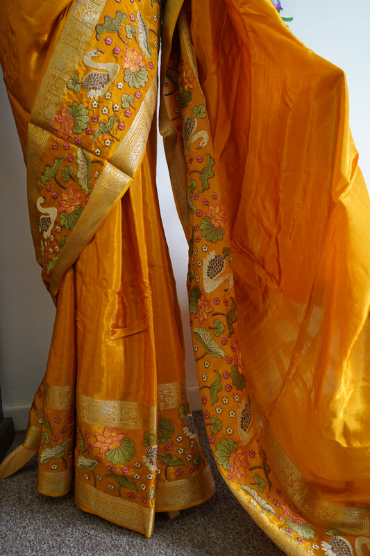 Mysore crepe silk saree with green stitched embroidered blouse - Orange, & floral zari motifs